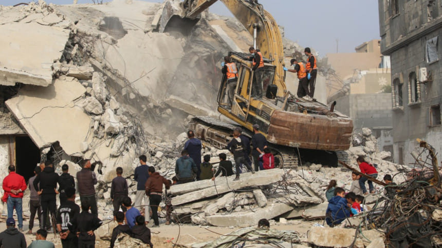 গাজার বুরেইজ শরণার্থী শিবিরে ইসরায়েলি হামলার পর ধ্বংসাবশেষ থেকে মরদেহ উদ্ধারের কাজ চলছে। ছবি: এএফপি (৬ ডিসেম্বর, ২০২৫)