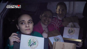 উপহারের ব্যাগ ও সনদ হাতে ছবির জন্য পোজ দিচ্ছেন তিন ইসরায়েলি জিম্মি। ছবি: এএফপি